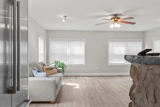 sitting room with ceiling fan and light hardwood / wood-style floors