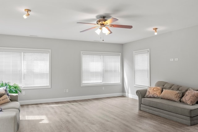 living room featuring ceiling fan and light wood-type flooring