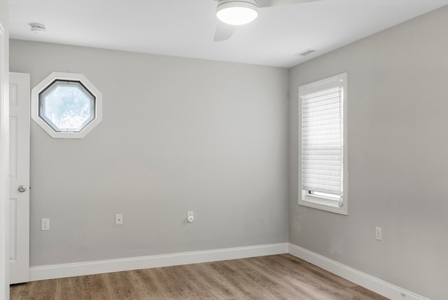 spare room featuring ceiling fan, plenty of natural light, and light hardwood / wood-style floors