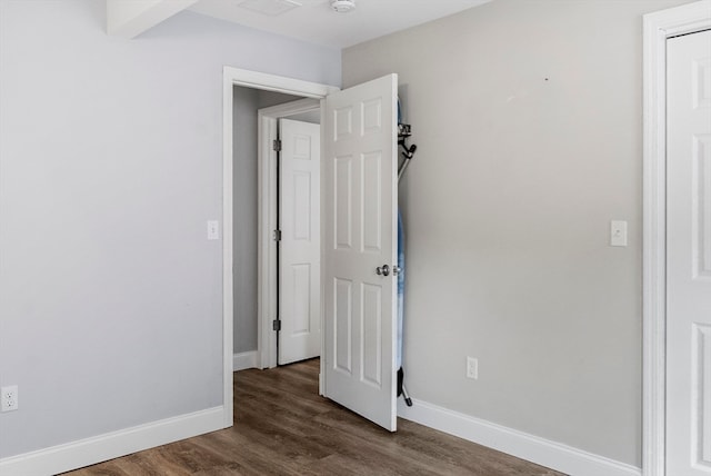 unfurnished room with dark hardwood / wood-style flooring