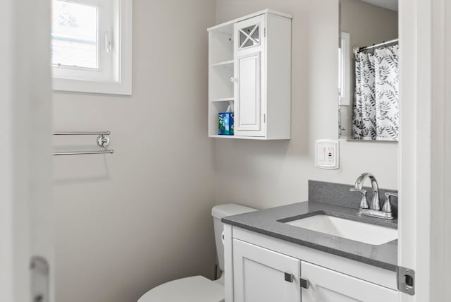 bathroom featuring vanity and toilet