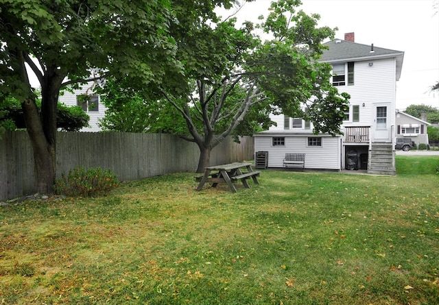 view of yard featuring central AC and a deck