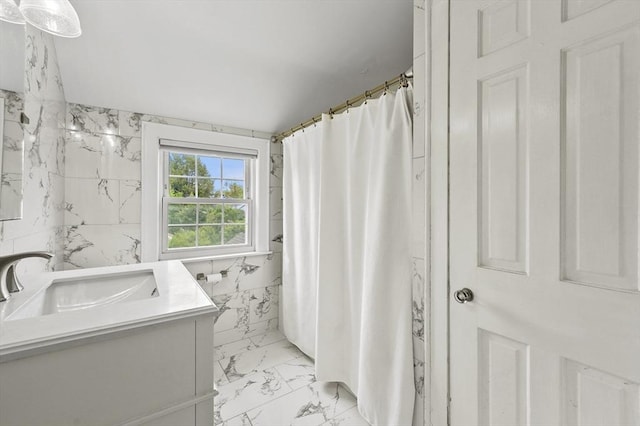 223 Warren St, Waltham, MA 02453 - full bath with marble look tile flooring, vanity, a shower with curtain, and tile walls