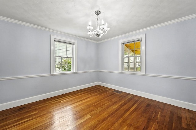 223 Warren St, Waltham, MA 02453 - unfurnished room with a chandelier, baseboards, hardwood / wood-style floors, and crown molding