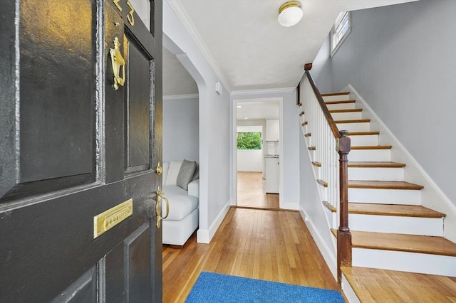 223 Warren St, Waltham, MA 02453 - entrance foyer with hardwood / wood-style floors, stairway, baseboards, crown molding, and arched walkways