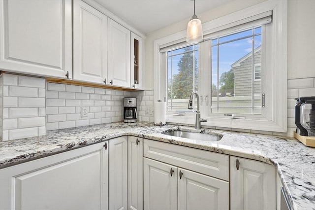 223 Warren St, Waltham, MA 02453 - kitchen with a sink, white cabinetry, and tasteful backsplash