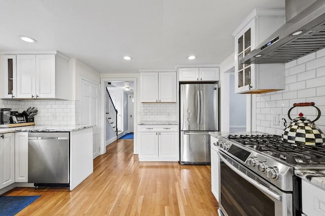223 Warren St, Waltham, MA 02453 - kitchen with appliances with stainless steel finishes, wall chimney range hood, backsplash, recessed lighting, and white cabinets