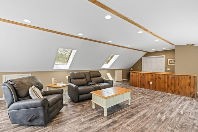 living room with lofted ceiling with skylight, wood finished floors, and recessed lighting