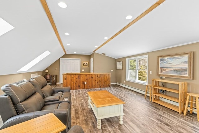 living room with a baseboard radiator, baseboards, vaulted ceiling with skylight, and wood finished floors
