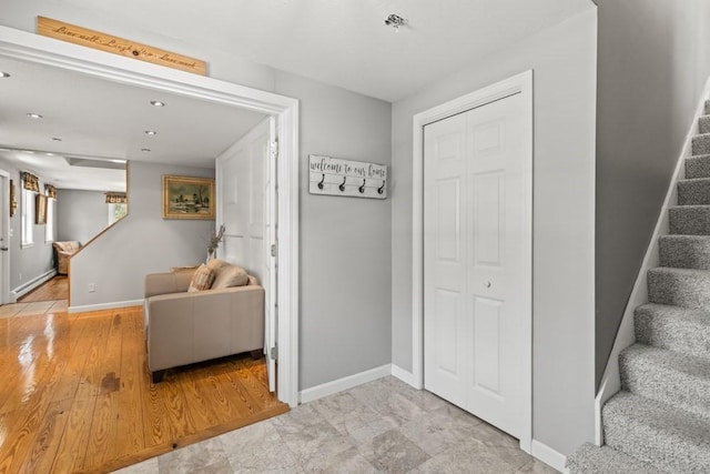 interior space featuring baseboards, recessed lighting, and stairway
