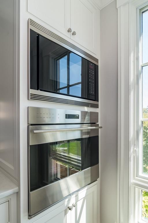 interior details featuring appliances with stainless steel finishes and white cabinetry