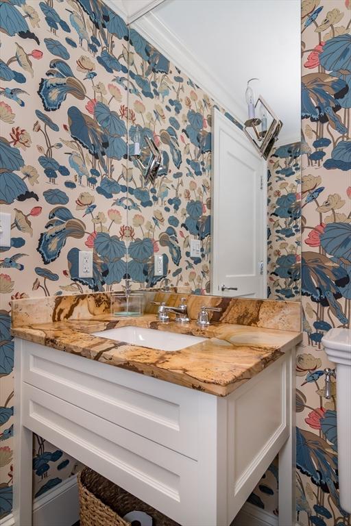 bathroom with vanity and ornamental molding