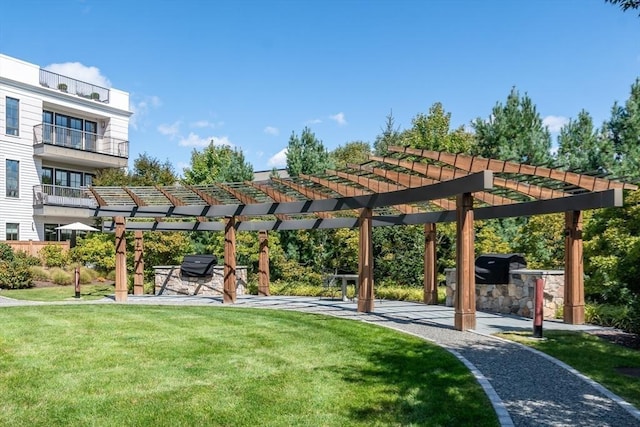 view of home's community with a pergola and a lawn