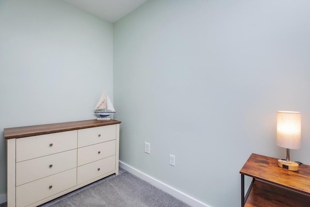 unfurnished bedroom featuring light carpet and baseboards