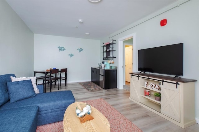 living area with light wood-type flooring and baseboards