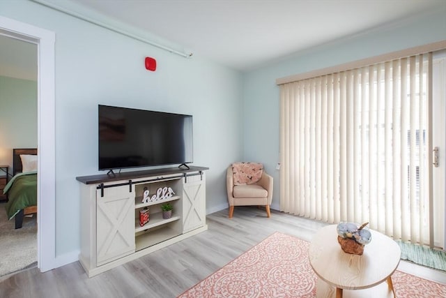 sitting room with light wood-style flooring and baseboards