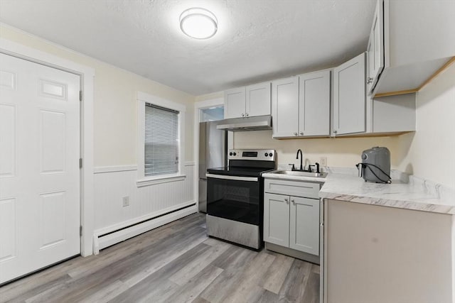 357 Granite St, Quincy, MA 02169 - kitchen featuring stainless steel range with electric stovetop, under cabinet range hood, a baseboard radiator, light wood finished floors, and light countertops