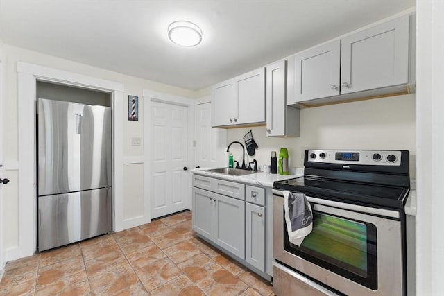 357 Granite St, Quincy, MA 02169 - kitchen with stainless steel appliances, light countertops, gray cabinetry, and light stone finish floors