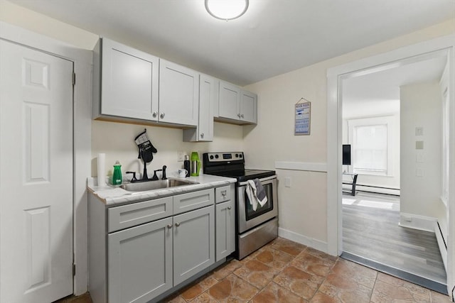 357 Granite St, Quincy, MA 02169 - kitchen with electric stove, light countertops, a baseboard heating unit, light stone finish floors, and gray cabinets