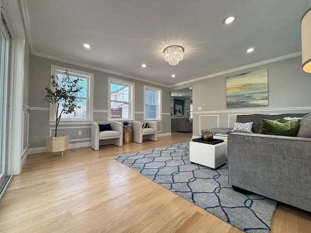 living room featuring recessed lighting, ornamental molding, baseboards, and wood finished floors