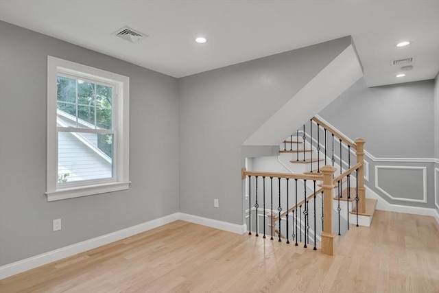 stairs featuring visible vents, recessed lighting, baseboards, and wood finished floors