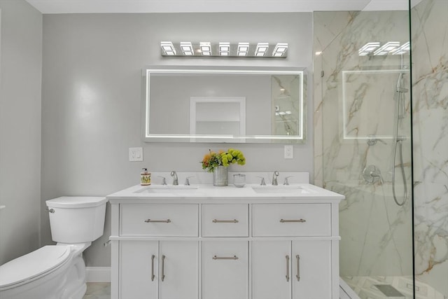 full bath with a sink, a marble finish shower, toilet, and double vanity