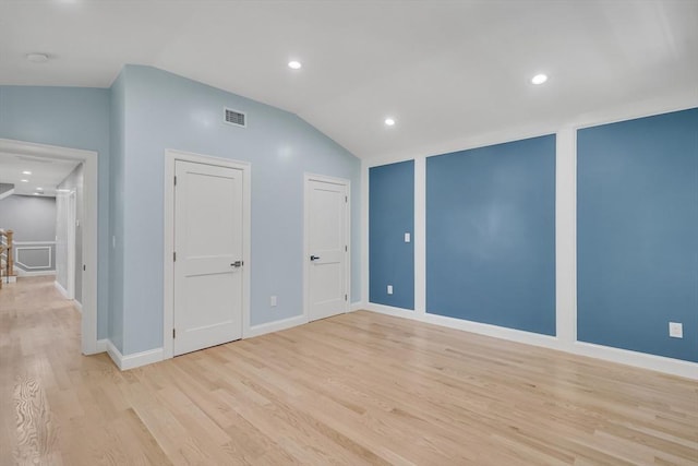 spare room with visible vents, recessed lighting, light wood finished floors, baseboards, and vaulted ceiling