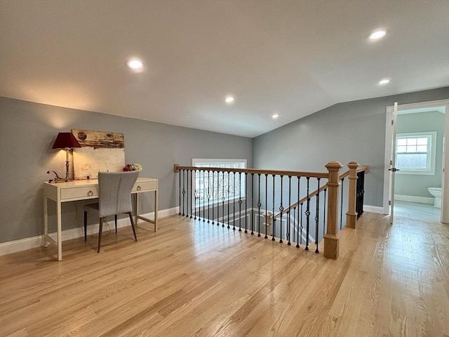 office space featuring vaulted ceiling, recessed lighting, baseboards, and wood finished floors