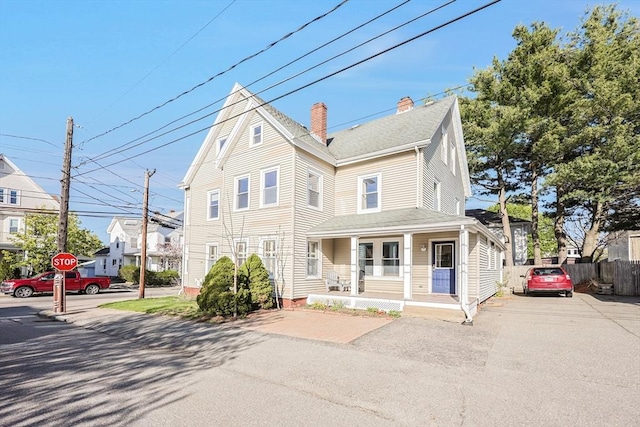 113 Taylor St Unit 1, Waltham, MA 02453 - view of front of property with fence, a chimney, and a porch