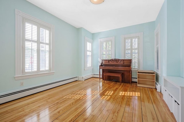113 Taylor St Unit 1, Waltham, MA 02453 - living area with a baseboard heating unit and light wood-type flooring