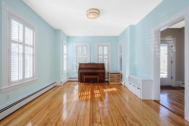 113 Taylor St Unit 1, Waltham, MA 02453 - interior space featuring light wood-type flooring, a baseboard radiator, and a baseboard heating unit