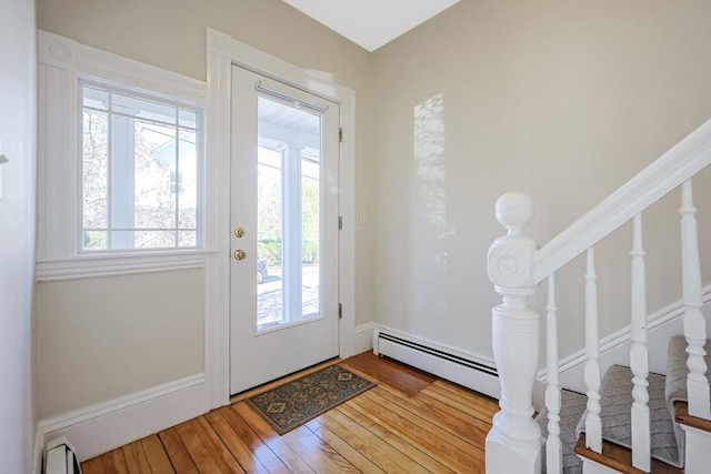 113 Taylor St Unit 1, Waltham, MA 02453 - entrance foyer featuring a baseboard radiator, hardwood / wood-style flooring, and stairs