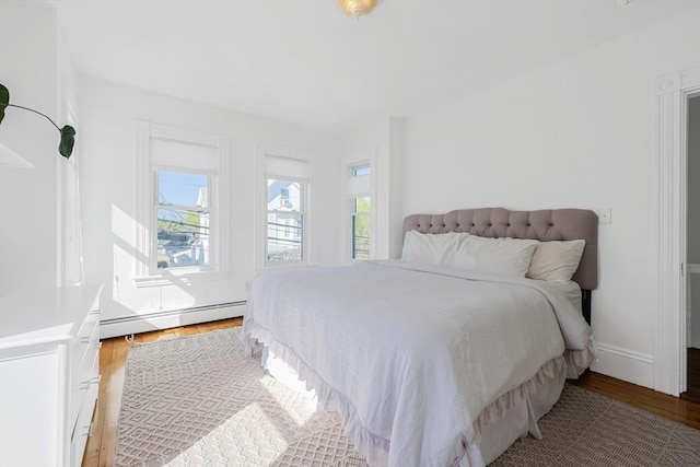 113 Taylor St Unit 1, Waltham, MA 02453 - bedroom featuring baseboard heating and light wood-type flooring