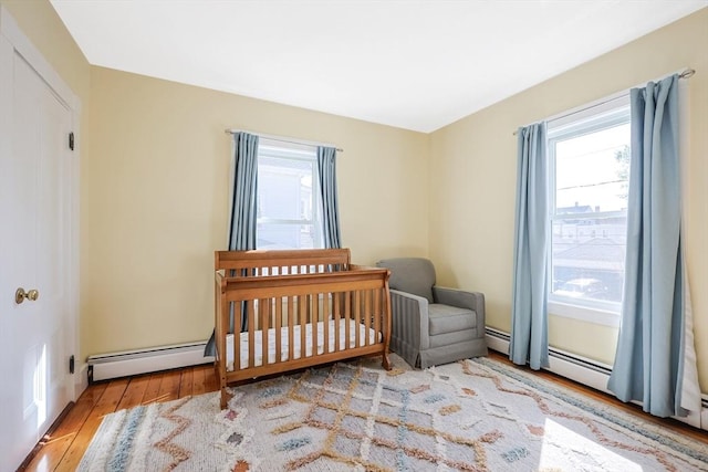 113 Taylor St Unit 1, Waltham, MA 02453 - bedroom with wood finished floors, a nursery area, and multiple windows