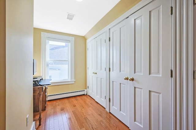113 Taylor St Unit 1, Waltham, MA 02453 - hall featuring visible vents, a baseboard heating unit, and light wood finished floors