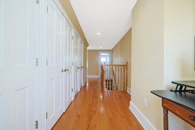 113 Taylor St Unit 1, Waltham, MA 02453 - hall featuring light wood-style floors, baseboards, recessed lighting, and an upstairs landing