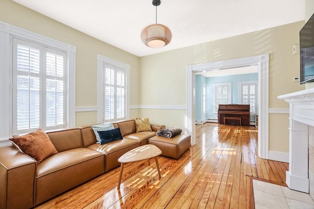 113 Taylor St Unit 1, Waltham, MA 02453 - living room featuring a fireplace with flush hearth and light wood finished floors