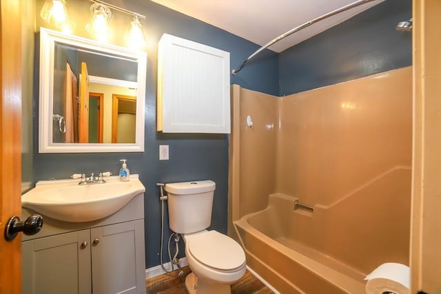 full bath with vanity, shower / bathing tub combination, baseboards, and toilet