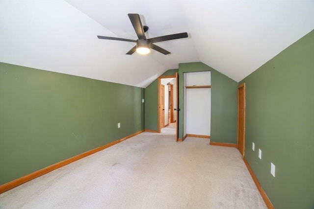 bonus room featuring baseboards, ceiling fan, vaulted ceiling, and light colored carpet