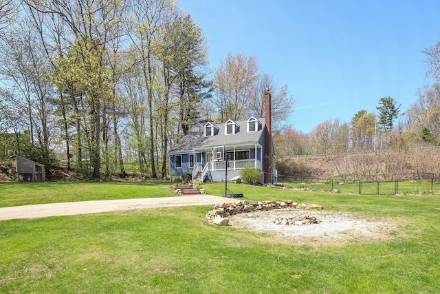 view of front of property with covered porch, stairway, a chimney, and a front lawn