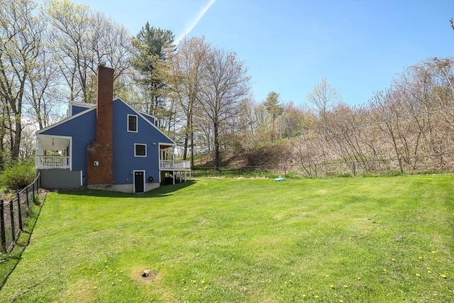 view of yard with fence and a wooden deck