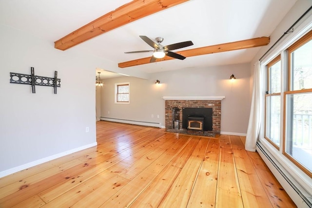 unfurnished living room featuring beam ceiling, baseboards, baseboard heating, a baseboard heating unit, and light wood-style flooring