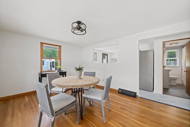 167 Green St, Abington, MA 02351 - dining space featuring plenty of natural light, light wood finished floors, and a chandelier