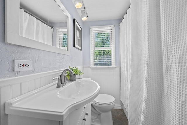 167 Green St, Abington, MA 02351 - bathroom with wainscoting, vanity, tile patterned flooring, and curtained shower