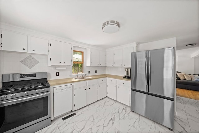 167 Green St, Abington, MA 02351 - kitchen with appliances with stainless steel finishes, light marble finish flooring, light countertops, and white cabinetry