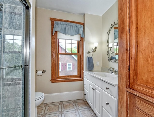 full bathroom featuring vanity, baseboards, and toilet