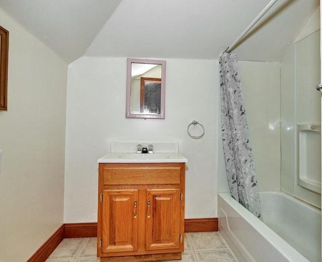 full bathroom featuring baseboards, vanity, and shower / bath combo