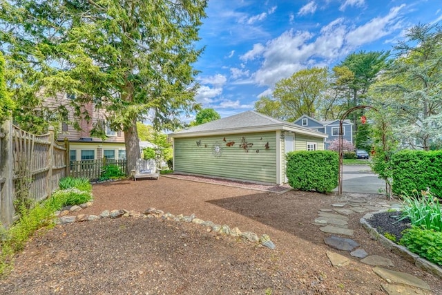 view of yard featuring fence and an outdoor structure