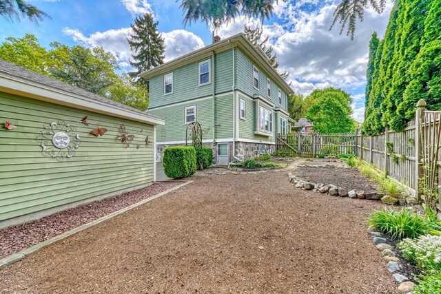 rear view of property with fence