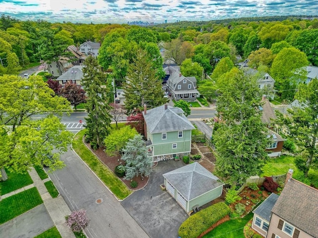 aerial view of residential area featuring a heavily wooded area